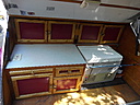 Galley with cabinets, flatware drawer, and cabinets below with battery storage