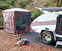 My Clam Traveler is big enough for the dog, his bed, his feeding station, me, a chair, and a heater if needed.  I have enough wind panels to cover all sides if needed.

Another thing I haven't tried yet is a bamboo stove cover/cutting board to give a bit more space to throw dinner together.